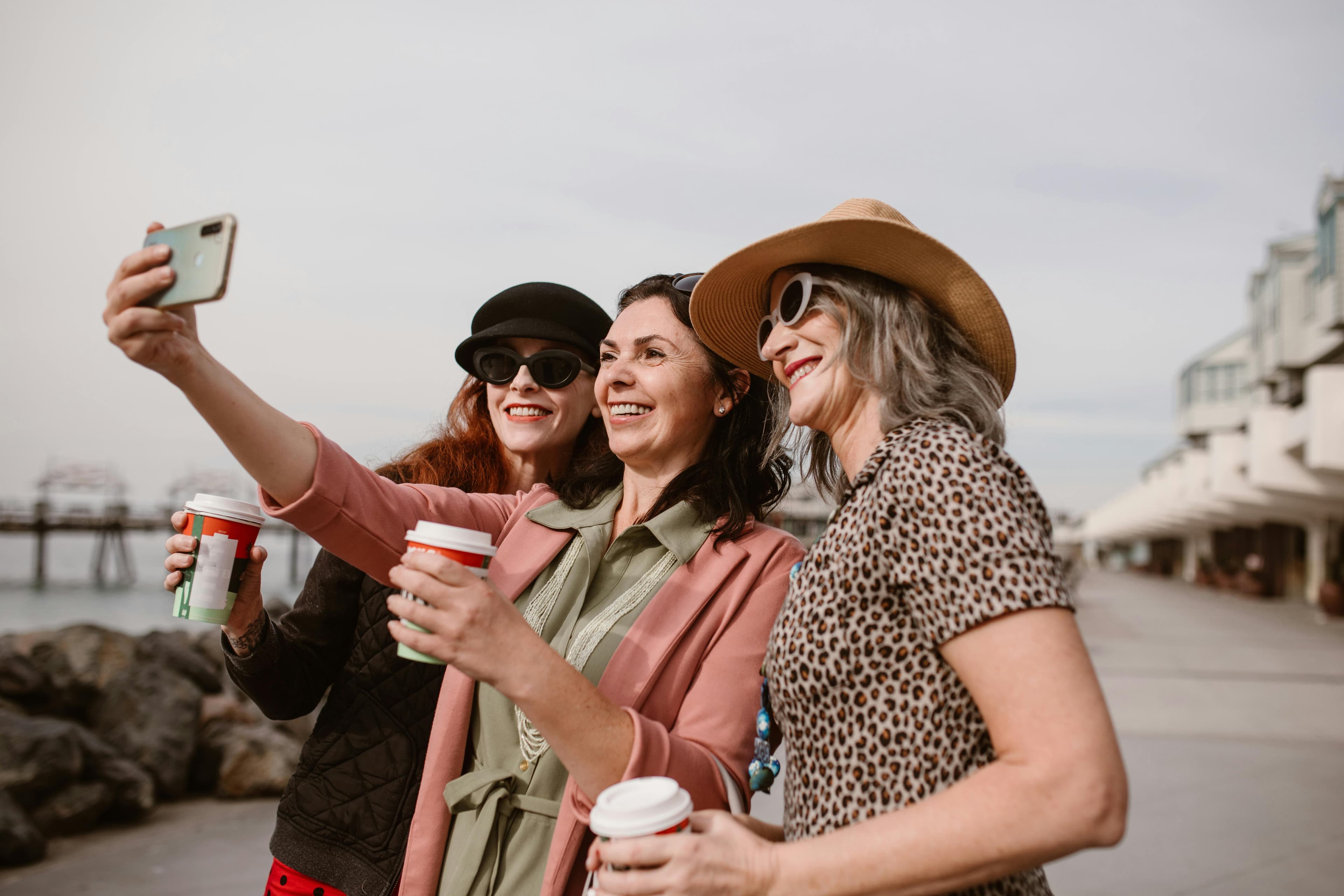 Three women friends taking a selfie together, representing authentic connection