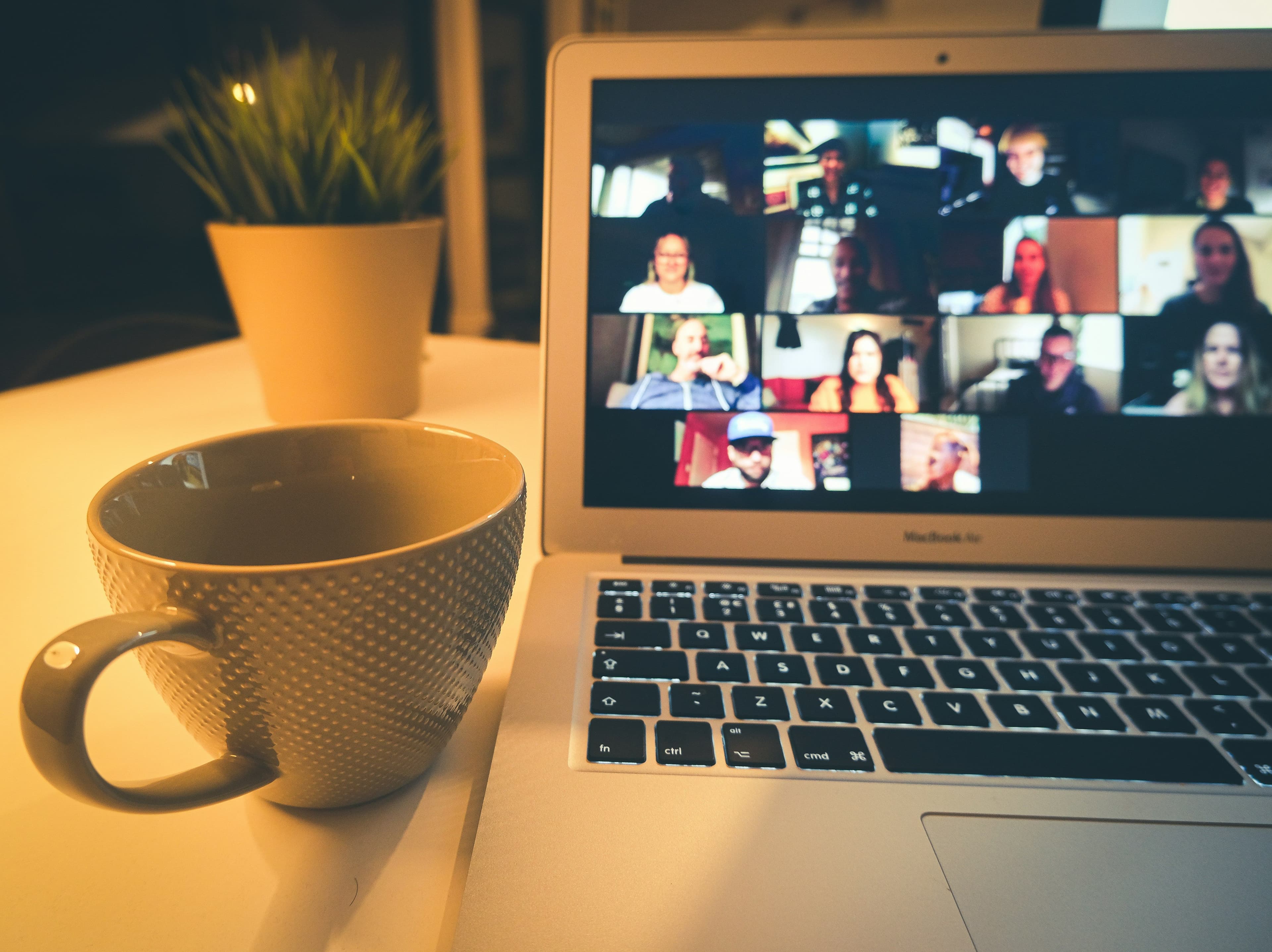 Laptop with video call and coffee mug